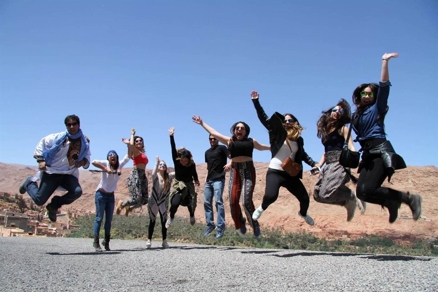 A small group jumping for joy in the Todra Gorge