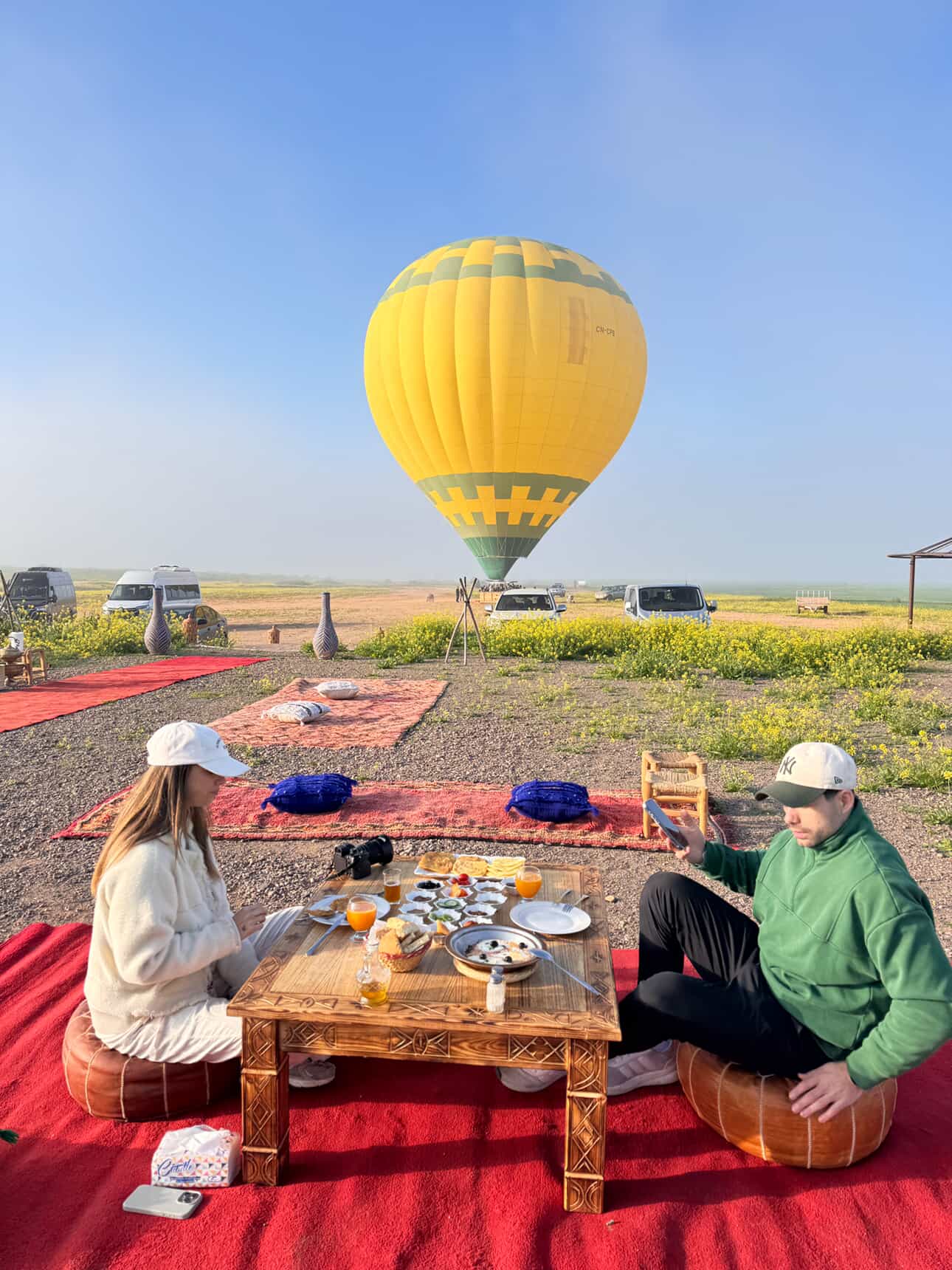 Traditional Moroccan breakfast served outdoors on carpets